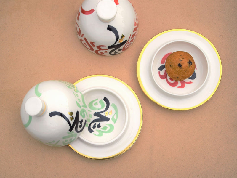 A set of two tajine inspired gold flaked butter dishes