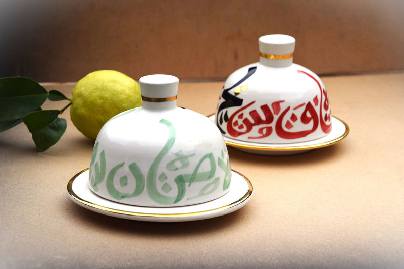 A set of two tajine inspired gold flaked butter dishes