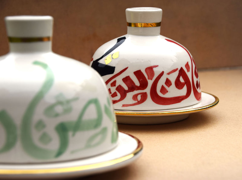 A set of two tajine inspired gold flaked butter dishes