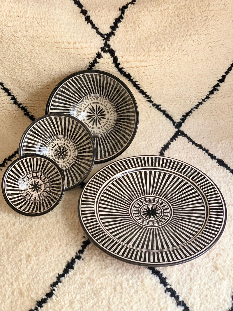 A set of three stunning and intricate black and white bowls and a plate