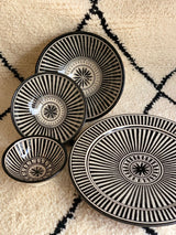 A set of three stunning and intricate black and white bowls and a plate