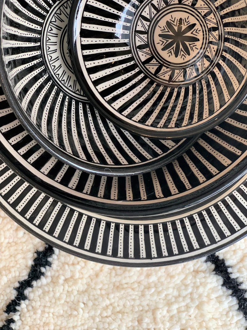 A set of three stunning and intricate black and white bowls and a plate