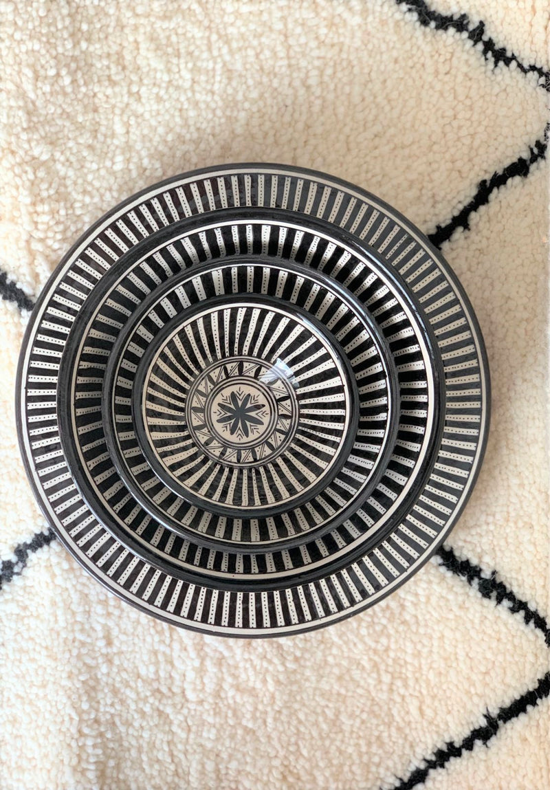 A set of three stunning and intricate black and white bowls and a plate